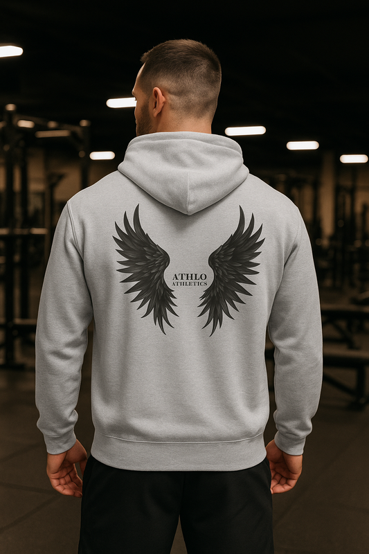 Person wearing a gray hoodie with wings and 'Athlo Athletics' text in a gym setting