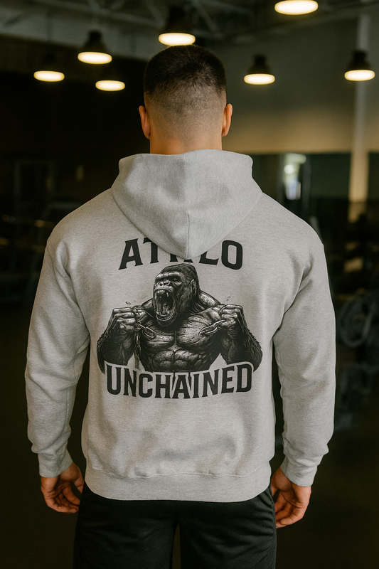 Person wearing a gray hoodie with a gorilla graphic and text on the back in an indoor setting.