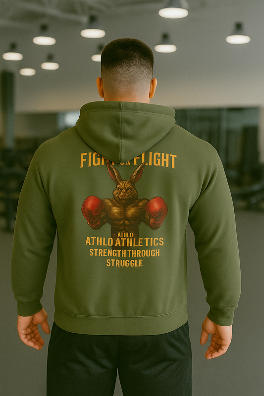 Person wearing a green hoodie with a graphic design on the back in an indoor setting.
