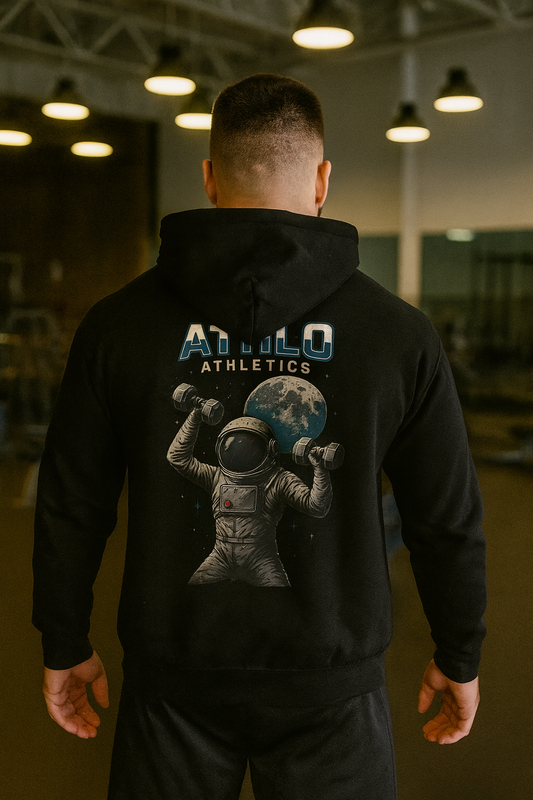 Person wearing a black hoodie with 'ATHLO Athletics' and an astronaut graphic on the back in a gym setting.